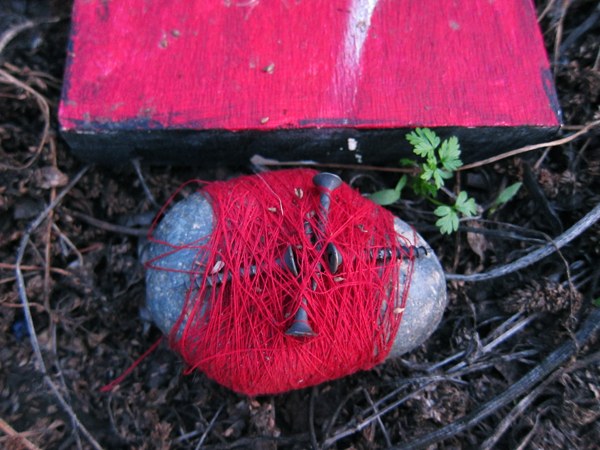 Magic Charm stone with red thread and screws